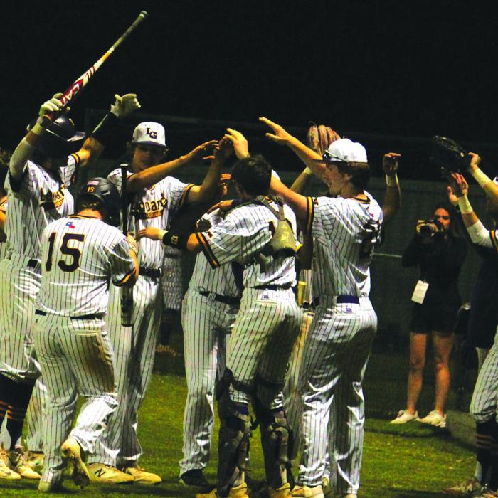 The players in the dugout come out to greet La Grange’s Landon Little after he scored a run Tuesday’s game against Smithville. Photos by Jeff Wick
