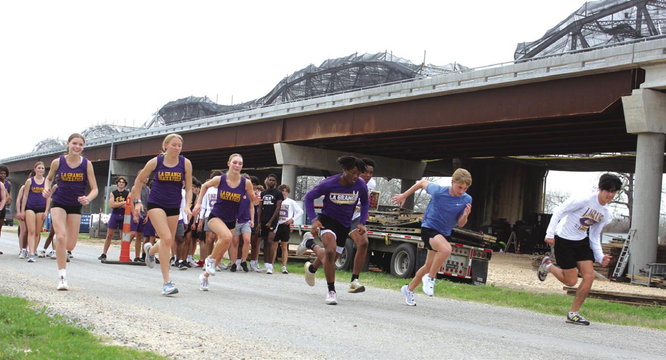 In an effort to give their athletes a different challenge, the La Grange track coaches bussed the high schoolers to the Colorado River area underneath the Business 71 bridges Tuesday to do some sprint work on the extreme uphill roadways there. Both the La Grange girls and boys track teams won the titles at their meet last week in Ganado, and host their home meet Thursday. Photo by Jeff Wick