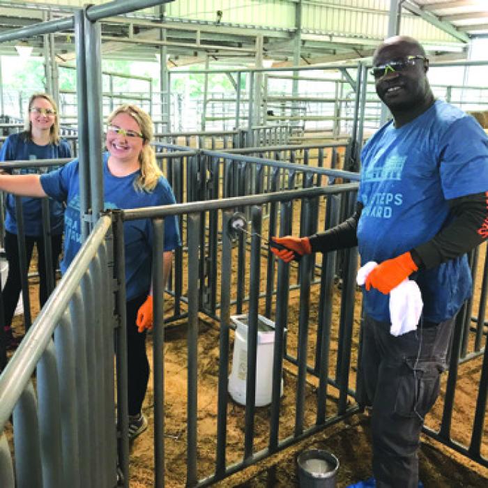 LCRA employees paint livestock pens at the Expo Center in Schulenburg during LCRA’s Steps Forward Day on April 14.