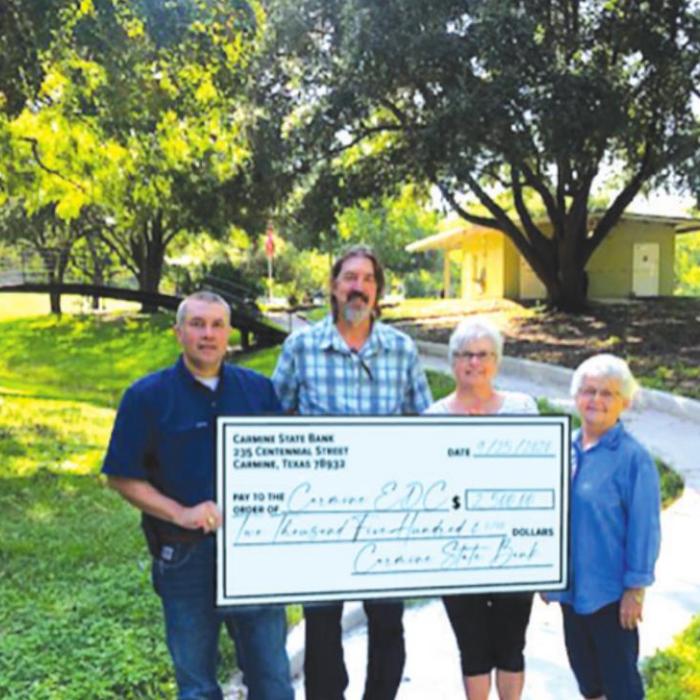 Pictured (from left) are Chris Coufal, President of Carmine State Bank, Richard Thames, Susan Bathe, and Vicki LaRue of the Carmine Economic Development Board.