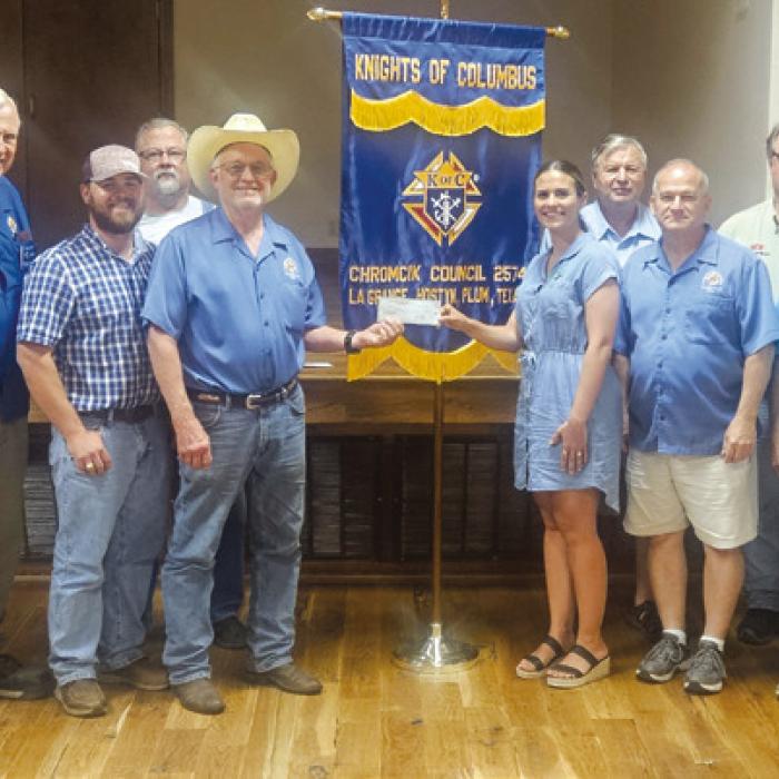 The La Grange Knights of Columbus Chromcik Council No. 2574 presented a $3,000 donation to the Turtle Wing Foundation. Accepting the donation is Destiny Siptak from Grand Knight Aaron Janda.
