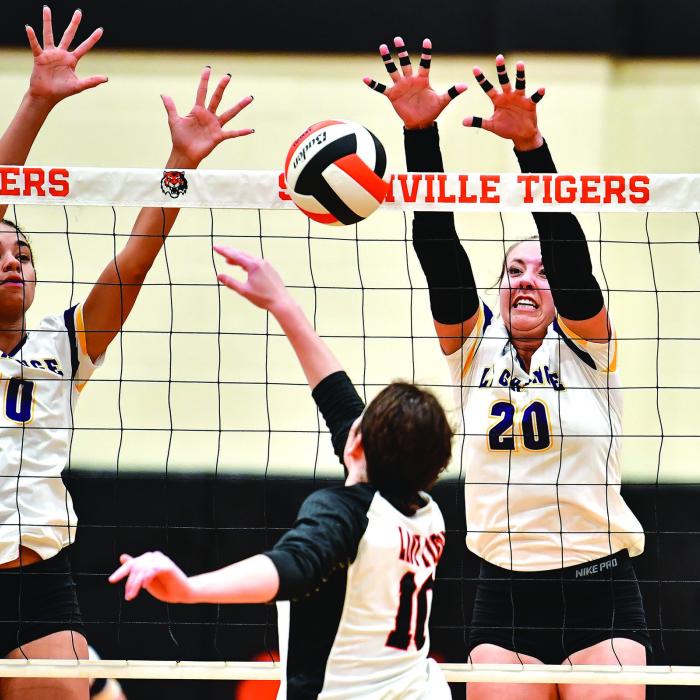 La Grange’s Camille Gonzalez, left, and Maddi Fritz, right, combine for a formidable force at the net in Tuesday’s match. Photos by Stephanie Steinhauser