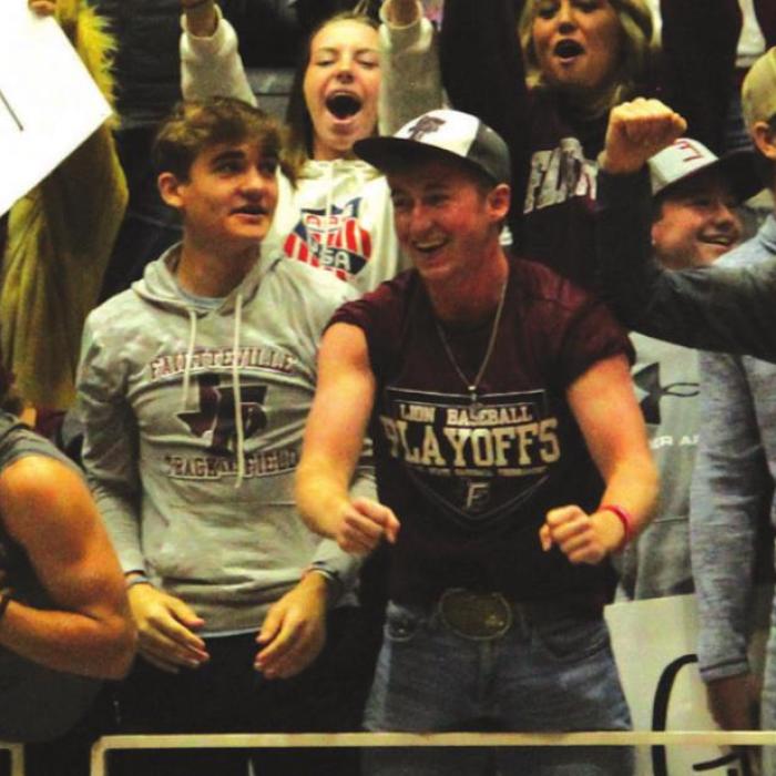 Fayetteville students fans cheering from the front row when a TV crew came by.