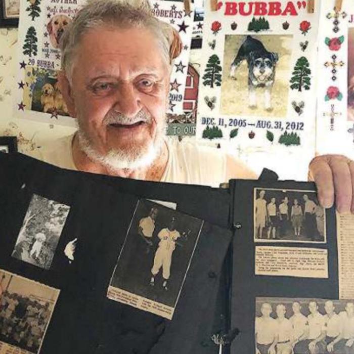 Richard “Moose” Roberts holds up newspaper clipping from his childhood memories in La Grange. Photo by Elaine Thomas