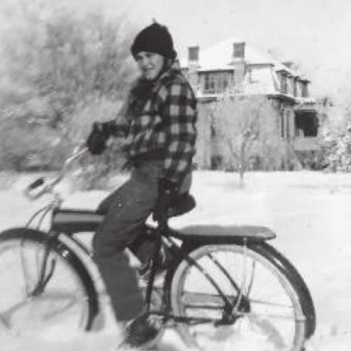 Moose was out on his bike immediately following a rare snowfall in La Grange in the 1940s. In the background is the Studemann-Duncan house that was also located on South Main Street.