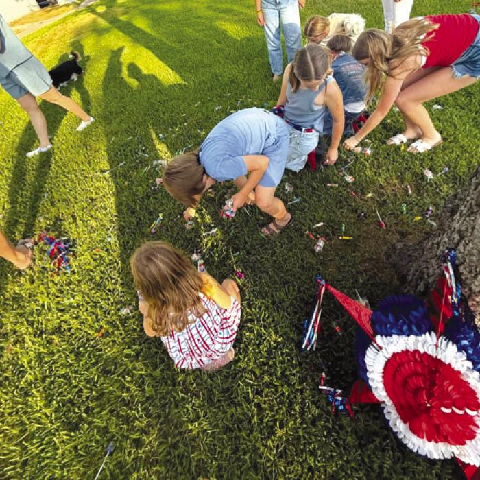 Playing with a pinata on the square during July 3 festivities. Photo by Morgan Zator