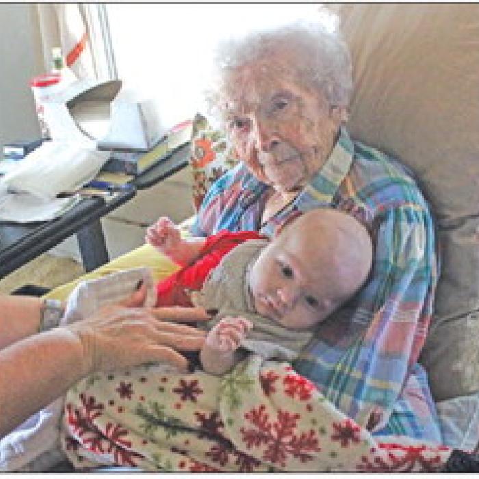 Mary Lee Mewis, 107, holds her two-month-old great great grandson Hudson during a visit at her home Friday. Photo by Jeff Wick