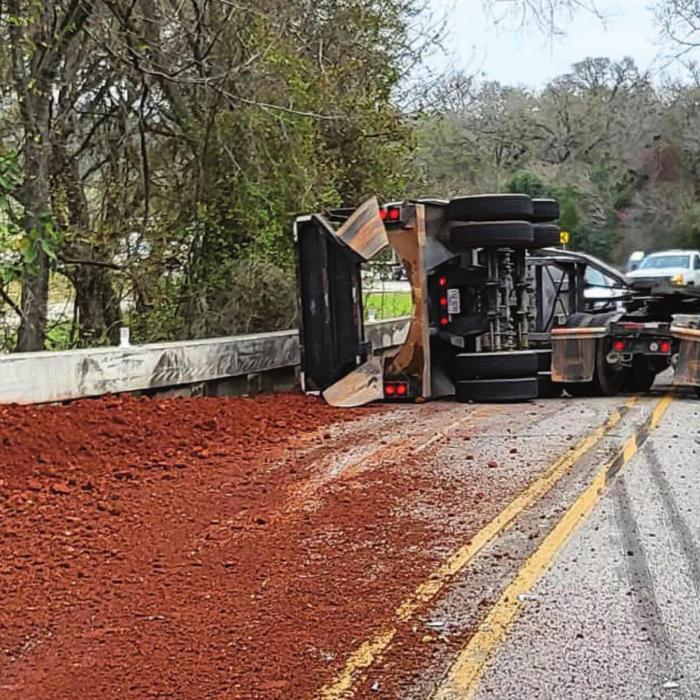 An 18-wheeler loaded with gravel rolled over on the Bluff Monday, precipitating an hours-long traffic jam in La Grange. Photo courtesy of the Fayette County Sheriff’s Office