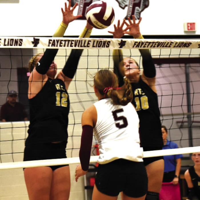 Round Top-Carmine’s Madison Markwardt, left, and Rebekah Sacks, right, jump to try to block this hit by Fayetteville’s Cambree Denham the first time these two district rivals met back on Oct. 13. These state-ranked foes face one another again this Friday at 6 p.m. in Carmine in the regular season finale. Photo by Paul Kipp