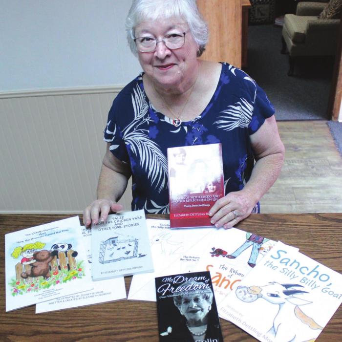 Elizabeth Dettling Moreno with several of the books she has written.