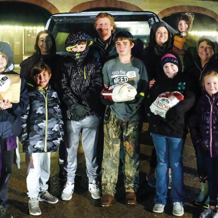 Feed the Need Mission of La Grange teamed up with youth volunteers from Fayette County 4-H to distribute about 200 turkeys and “gobble kits” on the Courthouse Square in La Grange on Monday, Nov. 21. Photo by Andy Behlen