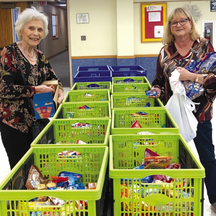 Fayette County Retired Teachers’ Association members fill the “goodie baskets” with snack items for active teachers/staff at all schools in Fayette County.