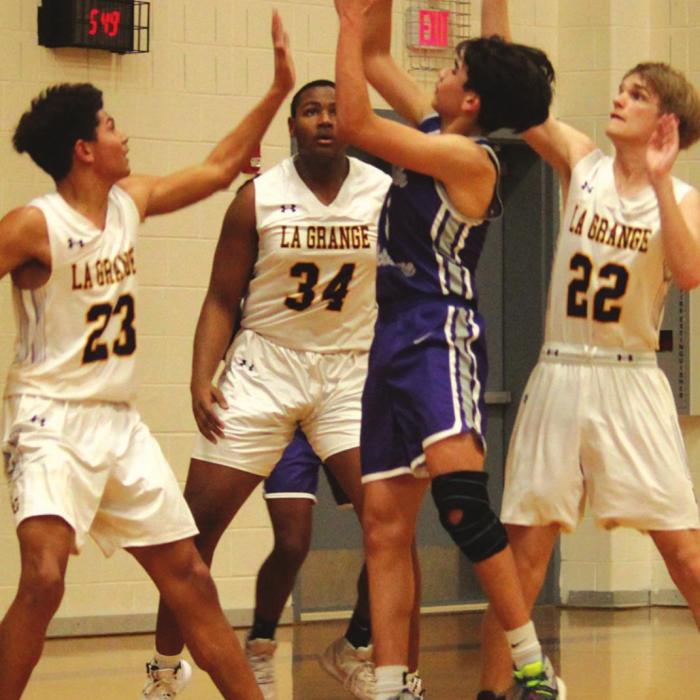 From left to right, La Grange’s Nate Scott, Jaron Woods and Ty Trlicek converge on this shooter from Austin Achieve Wednesday. Photos by Jeff Wick