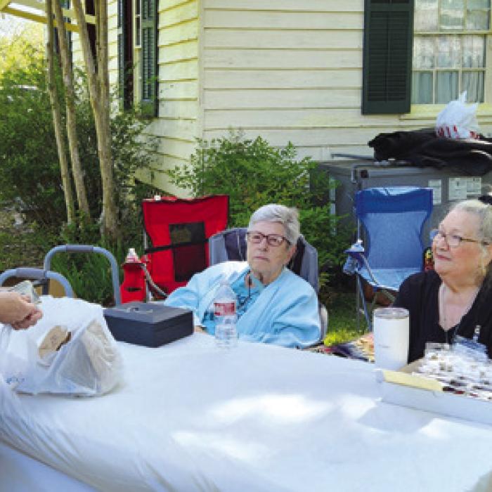 The annual La Grange Garden Club caladium bulb sale provided the makings for great summer color in the yards of La Grange. Seated are club members Anna Boyd and Alison Hammerbacher who waited on customer Deborah Penny.