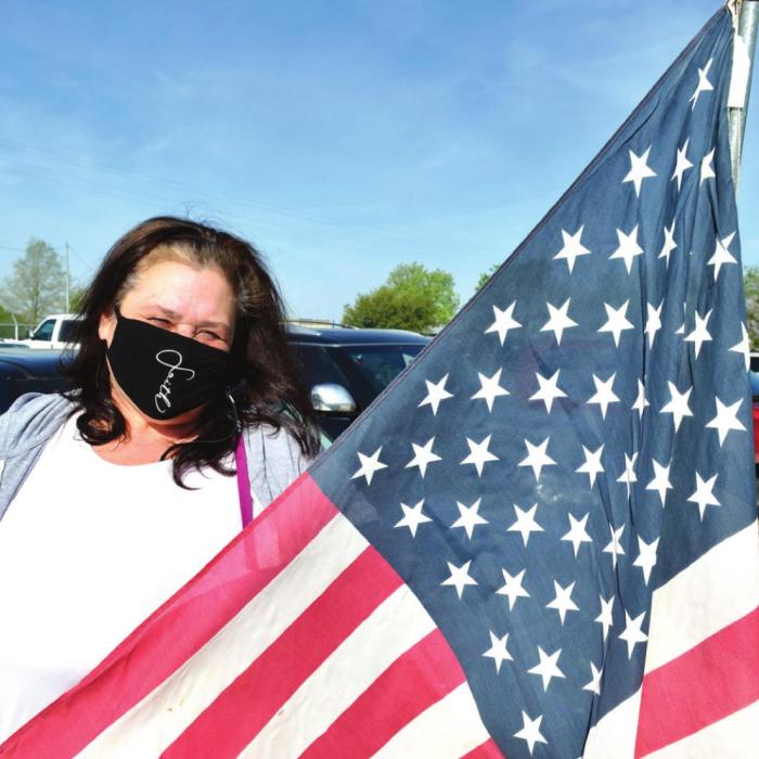 Sherry Faith saw that there was an American flag for sale at Second Chance Emporium in La Grange, so she was in line 90 minutes before the store opened at 9 a.m. Friday. She got her flag, which she will add to an Independence Day display on her front porch on Baumgarten Street in Schulenburg. Photo by Bill Bishop