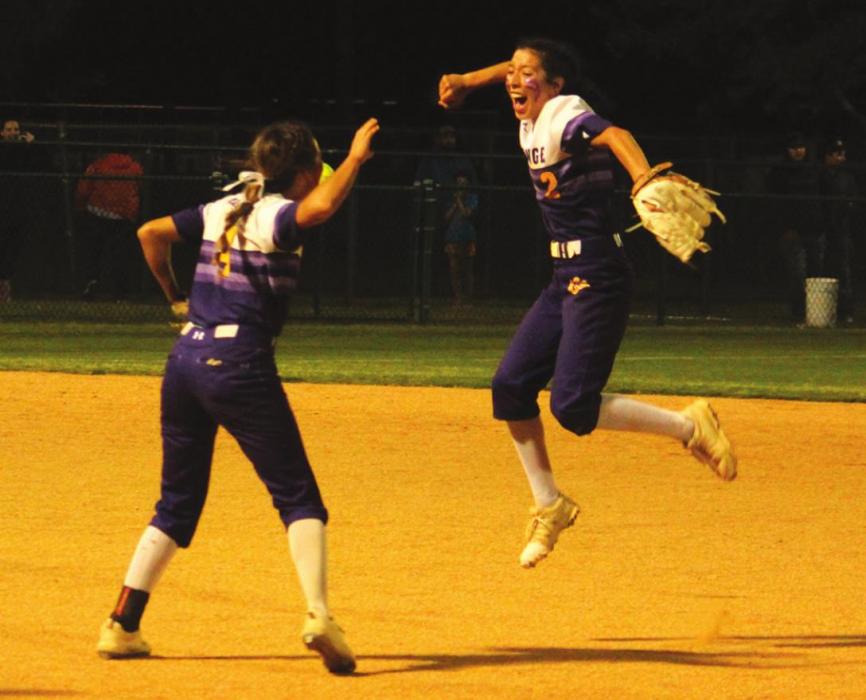 La Grange’s Landri Hernandez, right, leaps for joy after turning a game-ending unassisted double play as Abby Dela Rosa, left, joins the celebration.