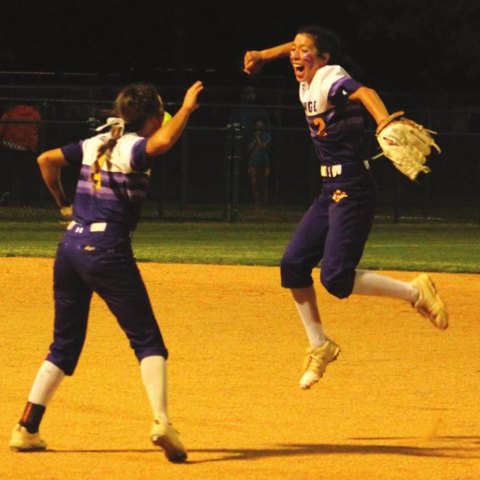 La Grange’s Landri Hernandez, right, leaps for joy after turning a game-ending unassisted double play as Abby Dela Rosa, left, joins the celebration.