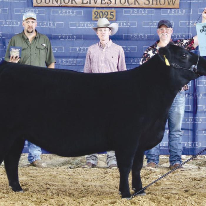 Grand Champion Heifer Overall and Grand Champion Haired Heifer - Peyton Gilchrest, Flatonia 4-H/La Grange FFA; Grand Champion Buckle Sponsor - KPK Manufacturing; Bradley Klesel - KPK Manufacturing, Caleb Boardman - Heifer Judge, Chris Gilchrest - Holding Banner.
