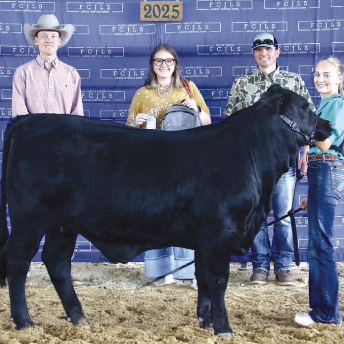 Grand Champion Commercial Heifer - Reisy Janca, Pure Country 4-H/La Grange FFA; Caleb Boardman - Heifer Judge, Morgan Dornak - Holding Bag, and Jay Janca.