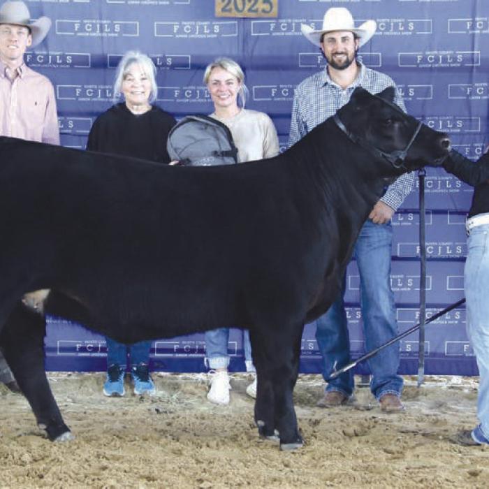 Reserve Champion Heifer Overall and Reserve Champion Haired Heifer - Addy Maass, Fayetteville 4-H/La Grange FFA; Reserve Champion Buckle Sponsor - In Memory of Frankie Joe Cernosek; Nettie Cernosek - In Memory of Frankie Joe Cernosek, Caleb Boardman - Heifer Judge, Vickie Hough, Paige Hough - Holding Bag, Adam Mayer, Doug Hough - Holding Banner.