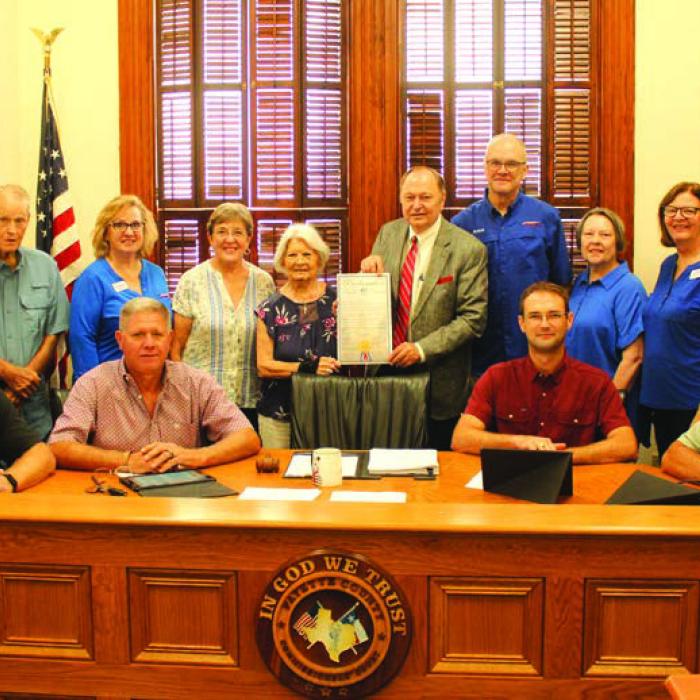 Left to right – Back: Jennifer Lane, Marilyn Cernoch, Billy Teague, Kathleen Kramr, Carolyn Heinsohn, Betty Danner, Judger Dan Mueller, John Bartos, Marilyn Kothmann, Cathleen Noska, Phyllis Teykl, Carolyn Surface; Front: Commissioners Drew Brossmann, Harvey Berckenhoff, Clint Sternadel and Jason McBroom. Photo by Jeff Wick