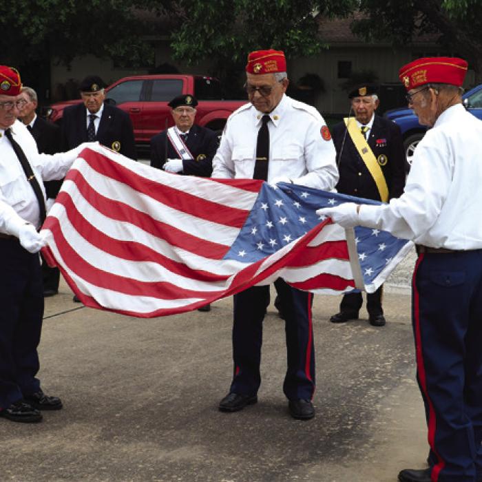 Koenig-Belvill Funeral Home in La Grange hosted their annual Memorial Day ceremony Monday. Above, left to right: County Judge Dan Mueller was the featured speaker, Marine Corps League #1028 retires the colors, above right, Shelby American Legion #602 with the placement of the new colors, and below right, VFW and American Legion representatives place a memorial wreath. Photos by Bobby Bedient
