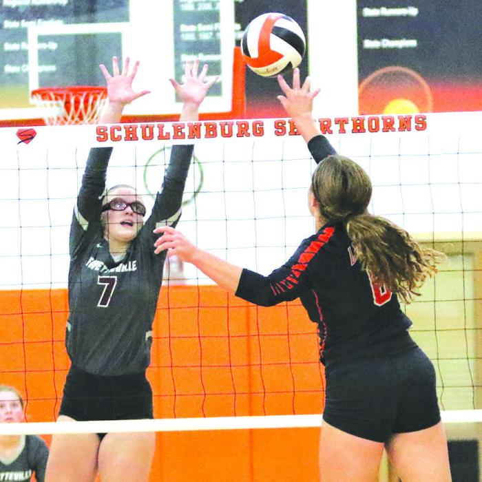Fayetteville’s Brooklyn Jaeger goes up for a block against the spike of Schulenburg’s Tamara Otto in Tuesday’s match.
