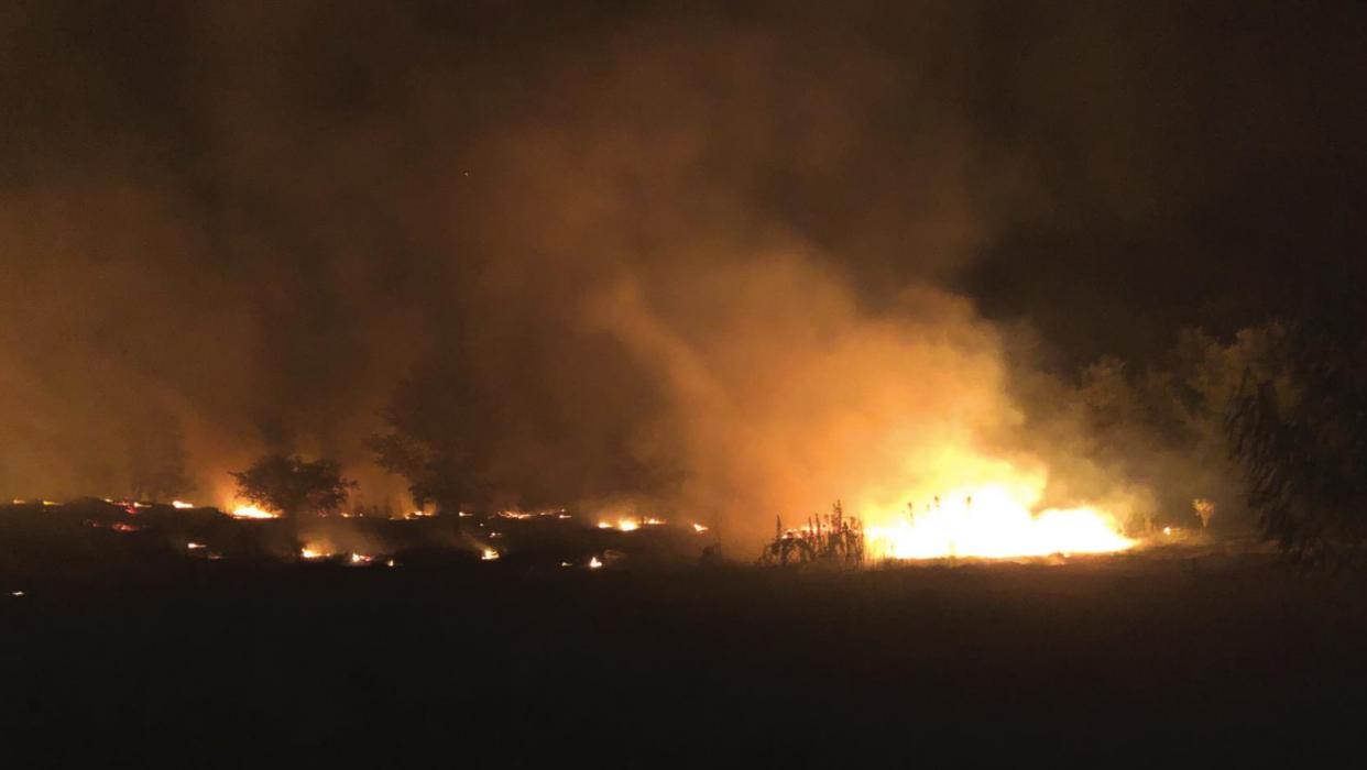 Someone set a three acre pile of discarded building materials on fire Tuesday night near Cozy Corner. The fire sent up a toxic plume of black smoke. Fire Chief Frank Menefee said he plans to speak with state officials about possible air quality violations. Photo courtesy of Frank Menefee