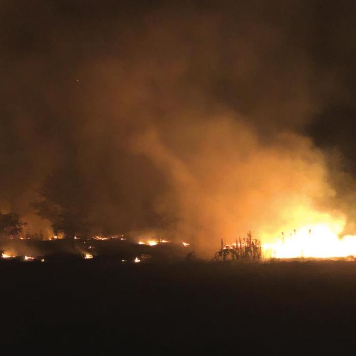 Someone set a three acre pile of discarded building materials on fire Tuesday night near Cozy Corner. The fire sent up a toxic plume of black smoke. Fire Chief Frank Menefee said he plans to speak with state officials about possible air quality violations. Photo courtesy of Frank Menefee