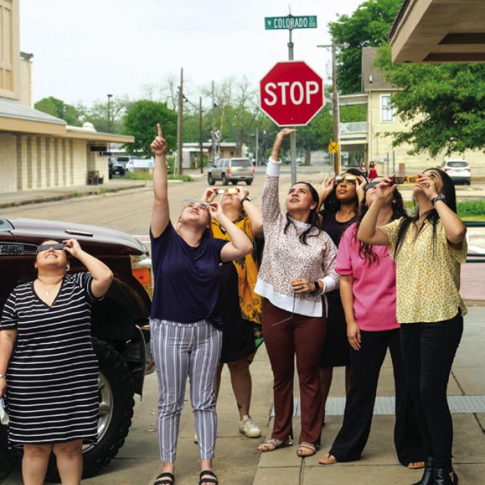 NBT bank employees ventured out of their offices to check out the eclipse in downtown La Grange. Photo by Andy Behlen