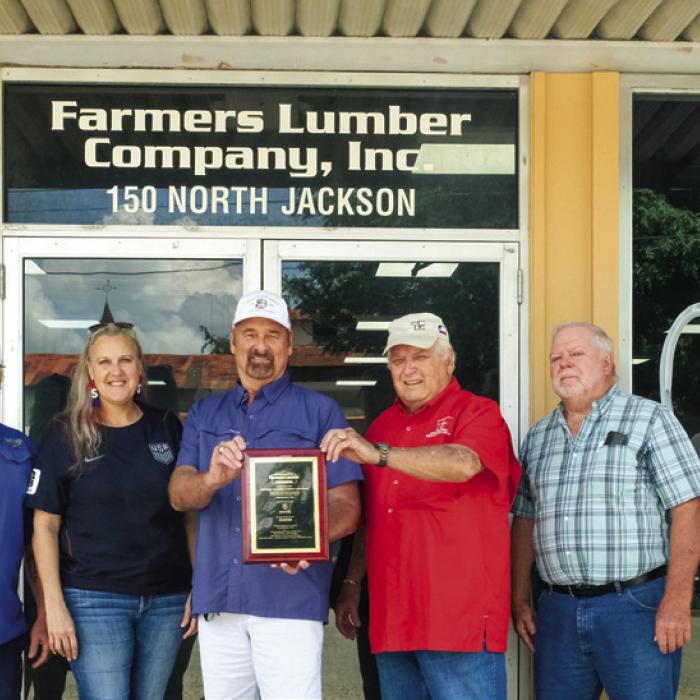 Farmers Lumber Company (FLC) held a grand re-opening celebration at their historic storefront on Jackson St. last Thursday. Pictured (from left) are general contractor Jeremy Conard of Conard Construction, Velvet Phillips of the distribution company Gaiennie Lumber, FLC General Manager Walt Jackson, FLC President Herb Janssen, FLC Vice President Harry Lehmann and Jacob Meadows of WindsorOne. Photos by Andy Behlen
