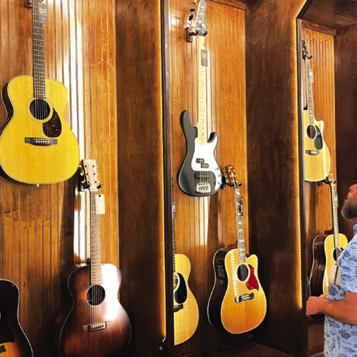 Andy Behlen admires the guitars at Fayette County Outfitters. Photo by Jeff Wick