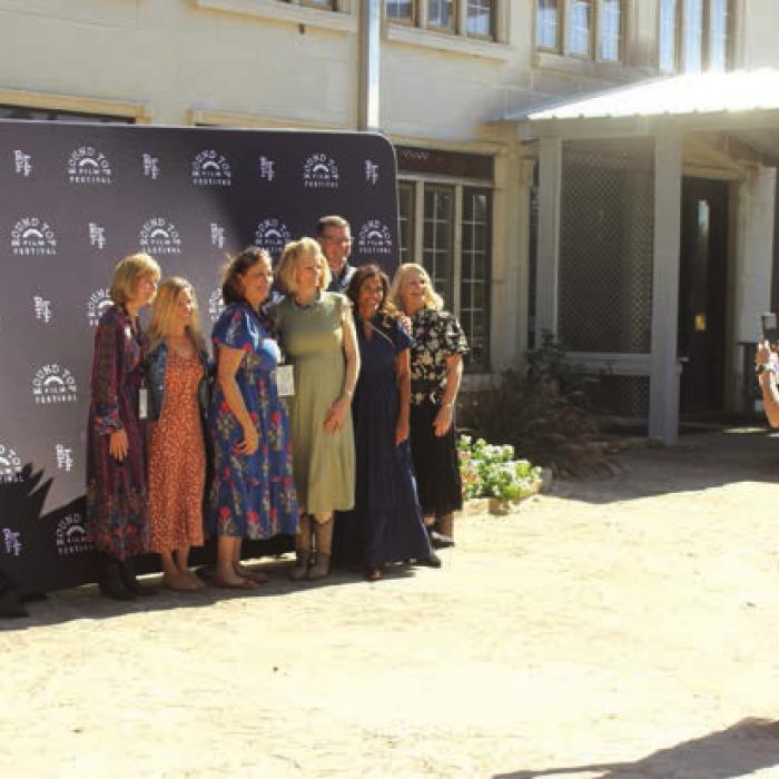 A group of ladies take a picture in front of film fest backdrop before heading into the concert hall to watch the Texas Shorts portion of Saturday’s program.