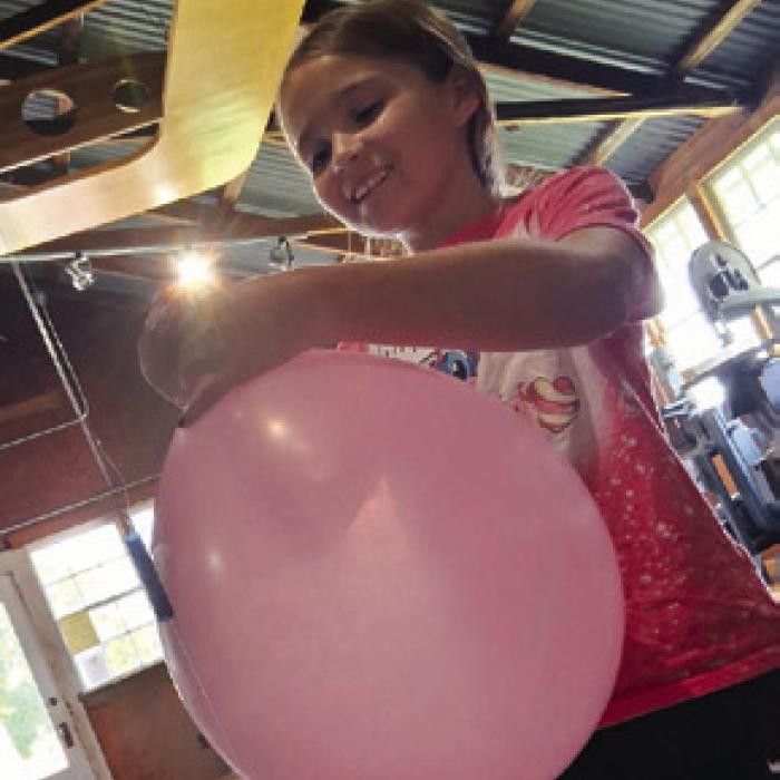 Lilly Muras prepares to launch her balloon rocket.