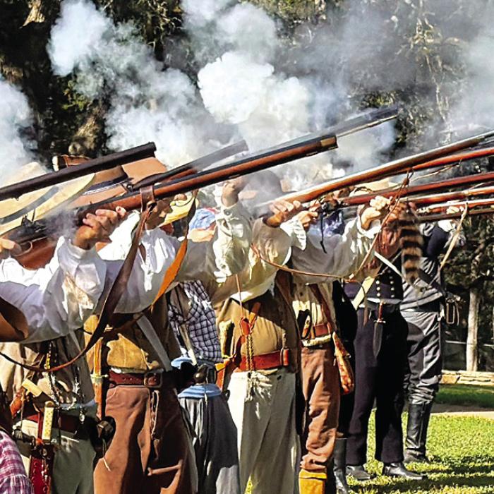 Texan Army Reenactors fired a three-volley salute to honor the men from the Dawson Massacre and Mier Expedition Saturday atop Monument Hill in La Grange. Photo by Andy Behlen