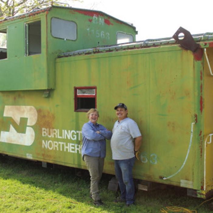 Charlie Brewer and Gary Gillentine out in front of the second caboose they are remodeling into a tiny home.