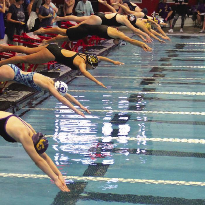 La Grange’s Hope Michalke and her competitors jump into the pool at the start of an event in Grapevine.