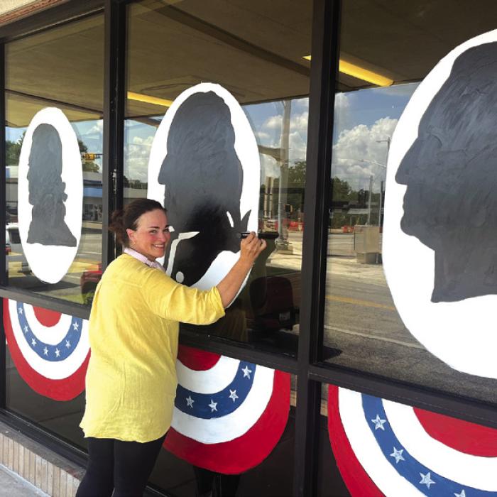 In honor of America’s 250th birthday this summer local businesses have been putting a little extra red, white and blue into their decorating. Above, local artist Bonnie Karstedt was hard at work on a massive art piece at Fayette Savings in La Grange that the bank plans to keep up into September. The area shown above is just one-fourth of the area Karstedt was painting. Photo by Jeff Wick