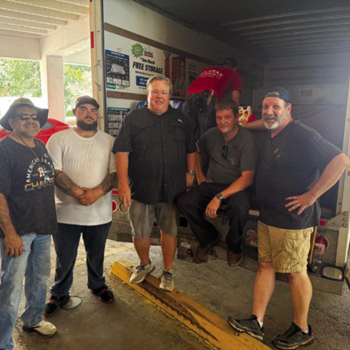 Masons picking up donated chairs.