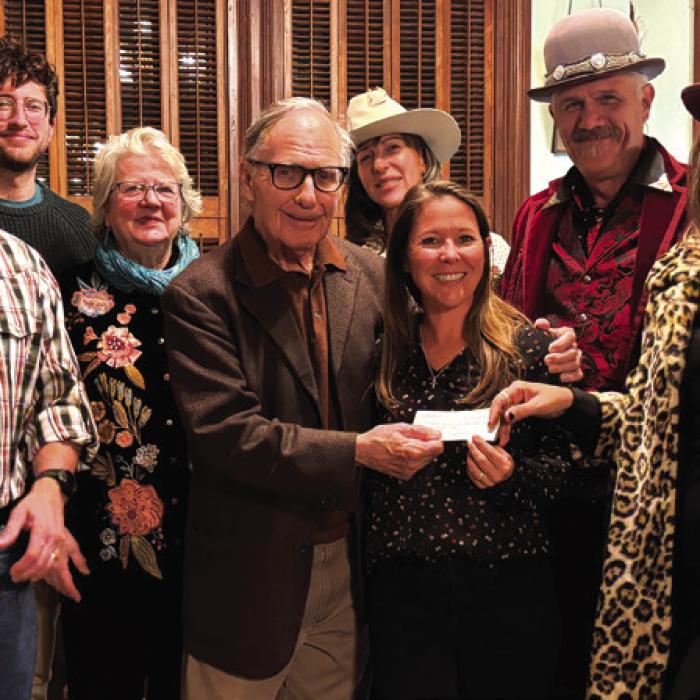 From left: accepting the check during the Round Top Chamber of Commerce Christmas Party RTFI Staff Chris Johnson, Ground’s Maintenance; James Dick, Founder and Artistic Director; Horticulturalist Julie Johnson and Crown Bar owner Beth Weishuhn; back row: Festival Hill Program Director Iverson Eliopoulos, staff member Pat Johnson, Vintage Clothing vendor Renee Rangel, and Crown Bar’s Andy Johnson.