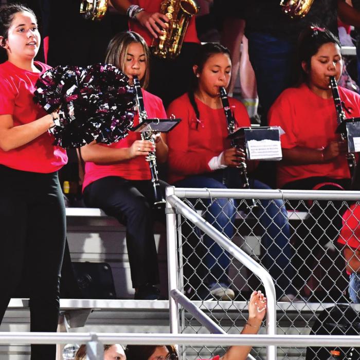 Flatonia Dazzler Elizabeth Palomera along with members of The Bulldog Band wear red and black (Texas Tech colors) in honor of Band Director Bob Hansen Friday night for the game in Falls City. Hansen suffered a heart attack Thursday and was hospitalized in Austin. Photo by Stephanie Steinhauser
