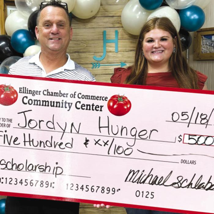 Chamber President Michael Schlabach presenting Jordyn Hunger a scholarship from the Ellinger Chamber of Commerce for $500.