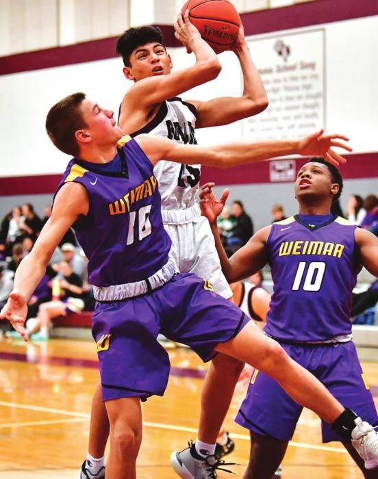 Angel Netro works through the Weimar defense to put a shot up for the Flatonia Bulldogs in Friday night’s district win over Weimar. Photo by Stephanie Steinhauser
