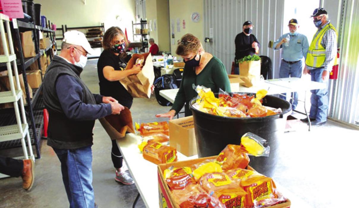 Even in the midst of COVID, volunteers continued to work at the AMEN food pantry, masks and all. Record file photo
