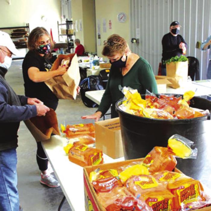 Even in the midst of COVID, volunteers continued to work at the AMEN food pantry, masks and all. Record file photo