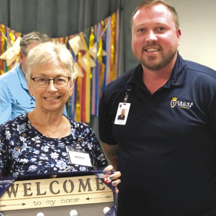 Recent black out bingo prize winner Peggy Haitt and bingo caller from Crown Hospice, Joshua Lovejoy.