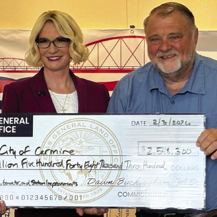 The City of Carmine recently received a grant from the Texas General Land Office for $2,548,300. Pictured are Commissioner Dawn Buckingham, MD, presenting the giant check to Wade Eilers, Mayor of Carmine. The funds will be used for a new water plant and water infrastructure upgrades.