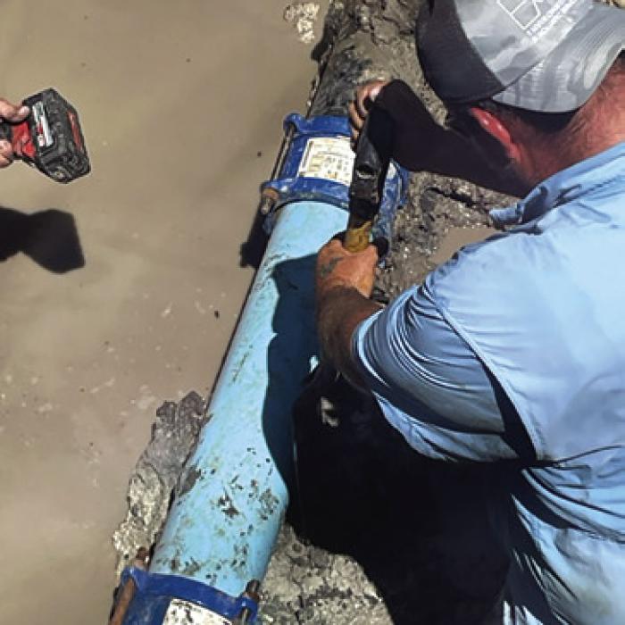 A man works to repair the water line Thursday in Fayetteville.