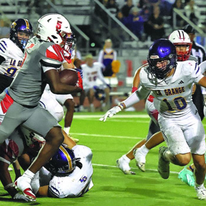 La Grange’s Koen Zbranek, 10, tries to close in on Bellville running back Travis Turner, who scored five touchdowns and ran for 250 yards Friday. Photo by Darrell D. Gest