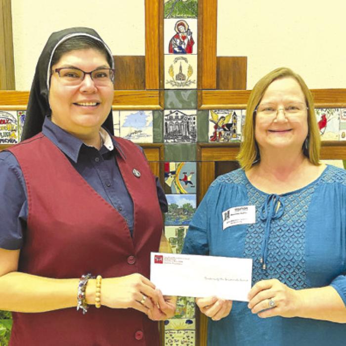 St. Rose of Lima Catholic School’s Change for Change Lenten Service Project raised $1,400. Sister Maria del Rosario Resendez is shown receiving the donation from Principal Rosanne Gallia. The donation benefits the Sisters of Incarnate Word and Blessed Sacrament Mission in Africa and Promise Point in Victoria.